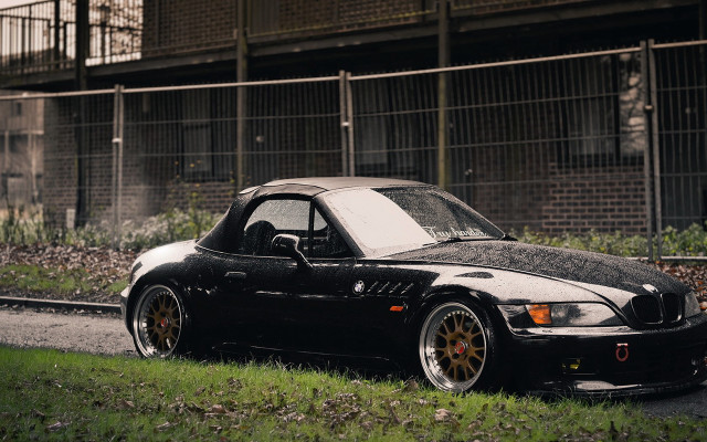 Black car road building fence free wallpaper - medium preview image