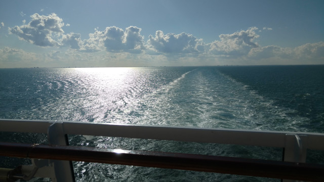 Boat horizon clouds city reflection free wallpaper - medium preview image