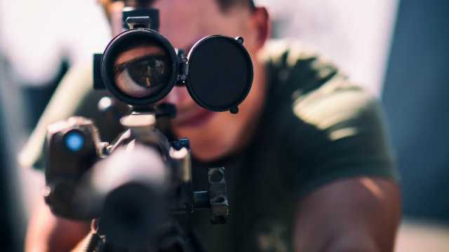 Man aiming gun scoped microscopic free wallpaper - medium preview image
