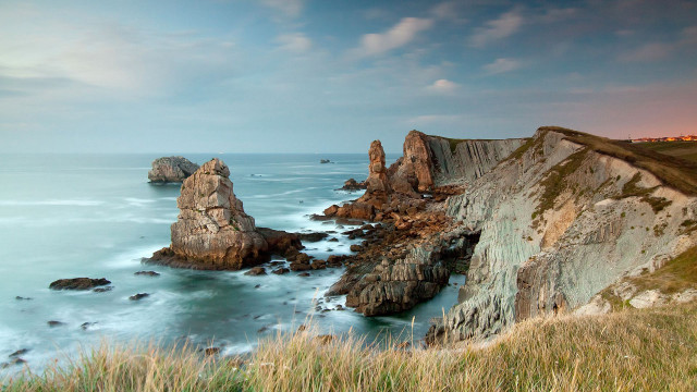 Cliff water beach rocks grass free wallpaper - medium preview image