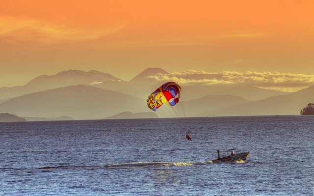 Parasailing ocean mountains sunset dawn free wallpaper - medium preview image