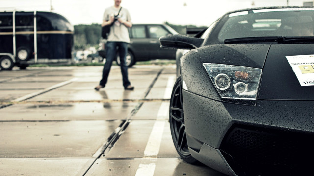 Man walking black sports car free wallpaper - medium preview image
