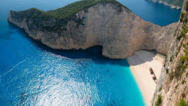 Beach rock formation boat cliff free wallpaper - medium preview image