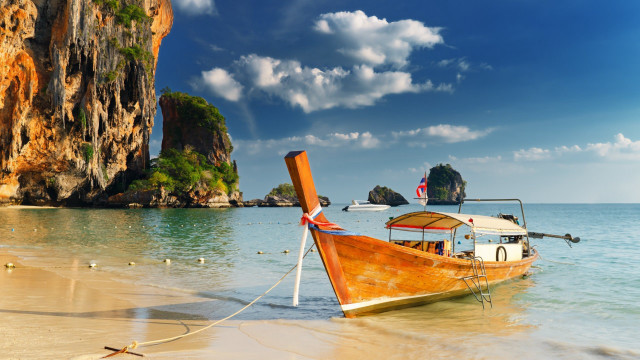 Boat flag rocks beach mountains free wallpaper - medium preview image
