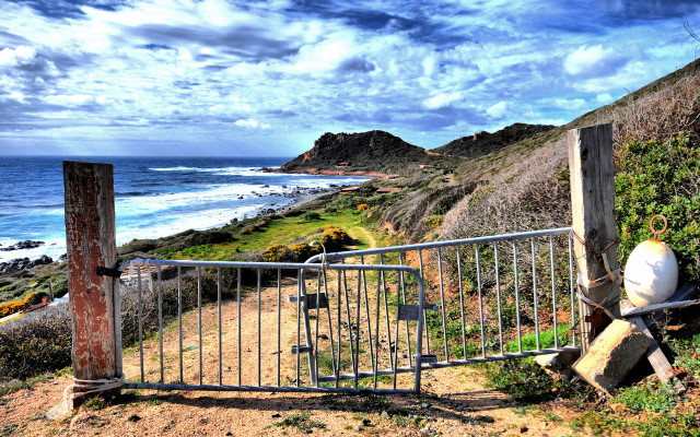 Gated ocean beach rocks cityscape free wallpaper - medium preview image