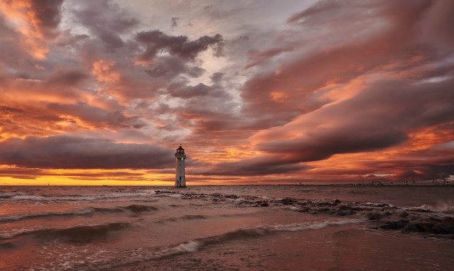 Lighthouse beach sunset clouds water free wallpaper - medium preview image