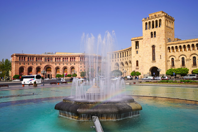 Fountain building rainbow bus cityscape free wallpaper - medium preview image