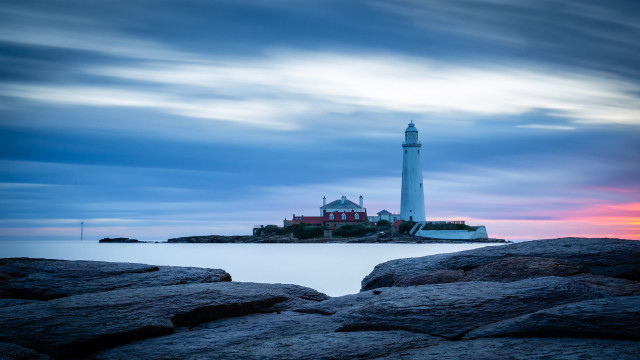 Lighthouse rocky shore sunset cloudy free wallpaper - medium preview image