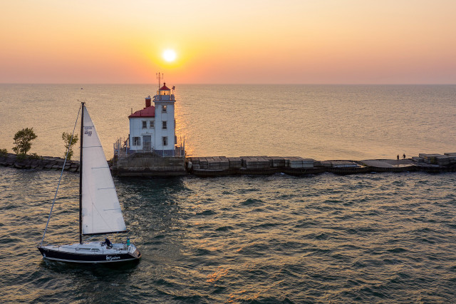 Sailboat lighthouse sunset ocean beach free wallpaper - medium preview image