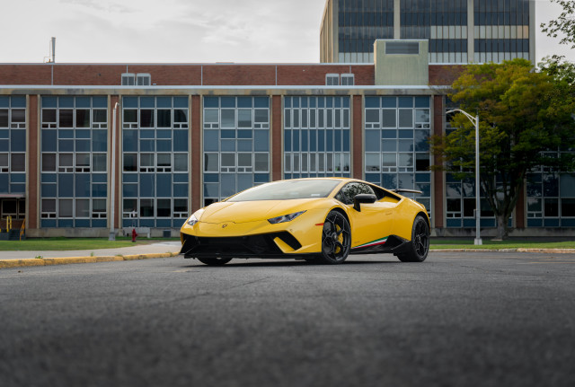 Yellow sports car windowed building free wallpaper - medium preview image