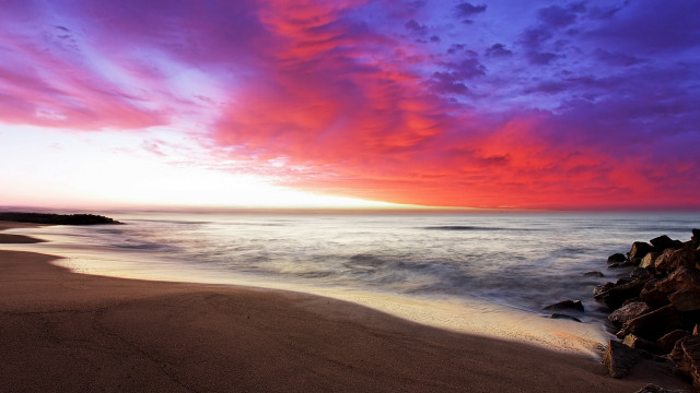 Beach rock outcropping sunset clouds free wallpaper - medium preview image