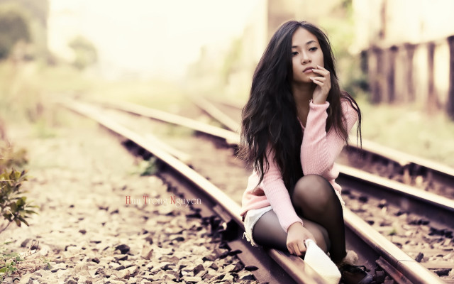 Woman sitting train track smiling free wallpaper - medium preview image
