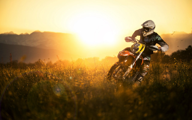 Dirt bike riding grassy field #2 free wallpaper - medium preview image