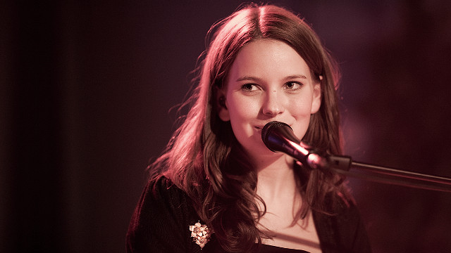 Woman singing microphone dark room #2 free wallpaper - medium preview image