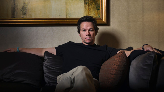 Man sitting couch legs crossed free wallpaper - medium preview image