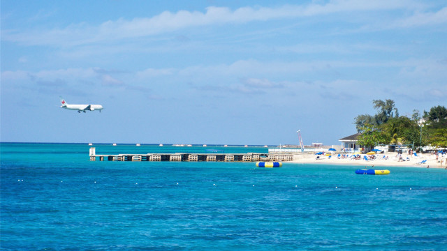 Plane beach pier umbrellas ocean free wallpaper - medium preview image