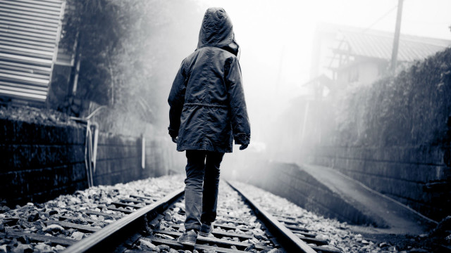 Person walking train track rain free wallpaper - medium preview image