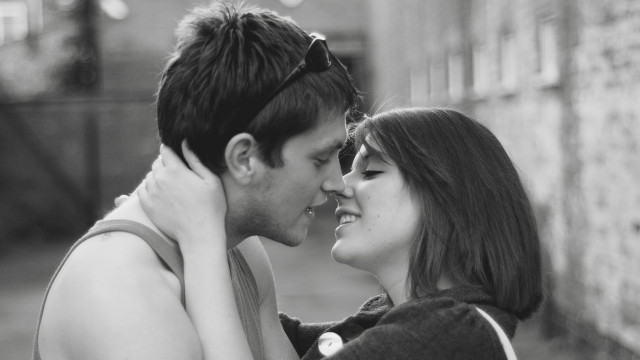 Man woman cuddling together street free wallpaper - medium preview image