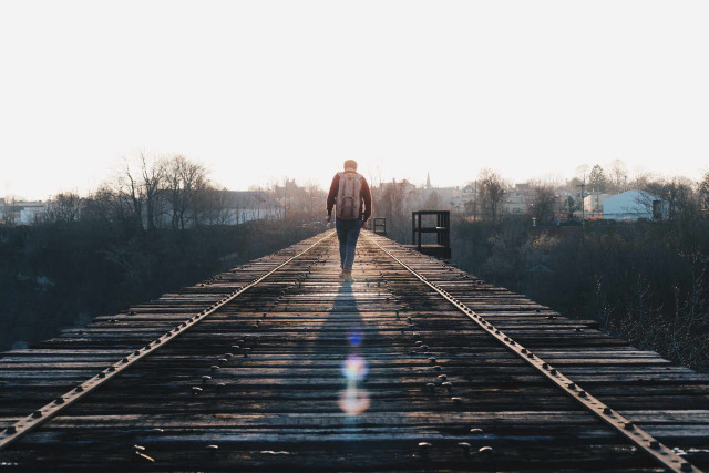 Man walking train track sunshine free wallpaper - medium preview image