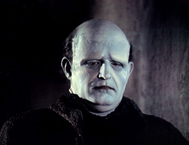 Bald man black sweater serious free wallpaper - medium preview image