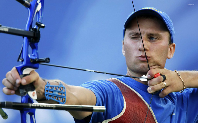 Man holding bow aiming smiling free wallpaper - medium preview image
