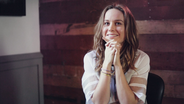 Woman smiling table hands folded free wallpaper - medium preview image