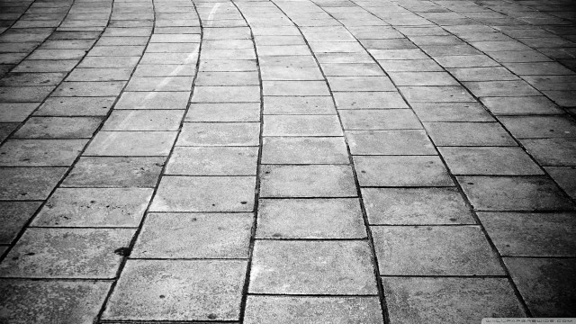 Brick sidewalk person walking monochrome free wallpaper - medium preview image
