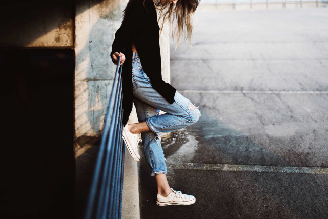 Woman leaning wall hands hips #2 free wallpaper - medium preview image