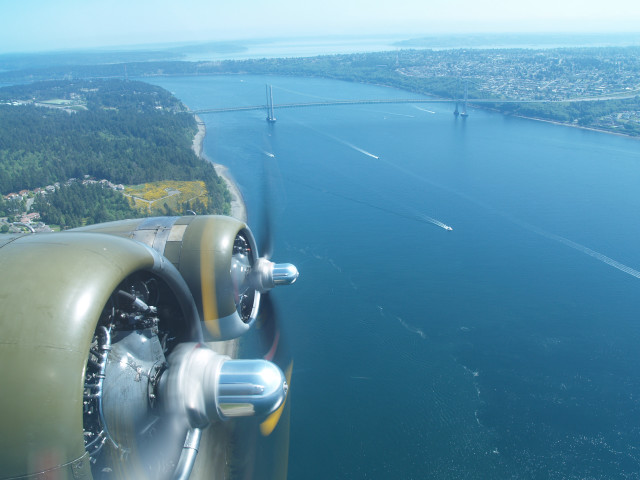 Propeller plane flying water bridge free wallpaper - medium preview image