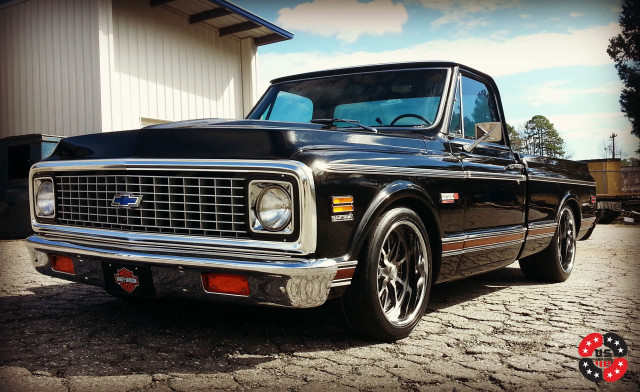 Black truck building dirt road free wallpaper - medium preview image