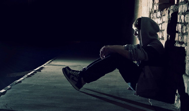 Person sitting ledgedark backpack lap free wallpaper - medium preview image