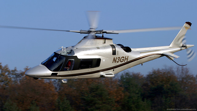 Helicopter flying forest trees blue free wallpaper - medium preview image