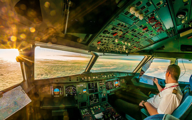 Man sitting cockpit plane pointing free wallpaper - medium preview image