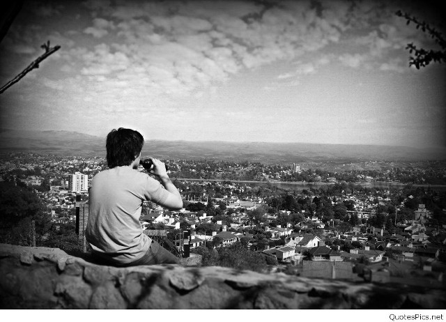 Man sitting rock city camera free wallpaper - medium preview image
