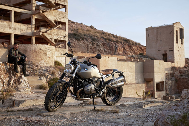 Motorcycle parked building man sitting free wallpaper - medium preview image