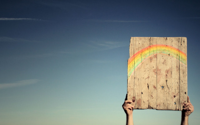 Person holding wooden sign rainbow free wallpaper - medium preview image