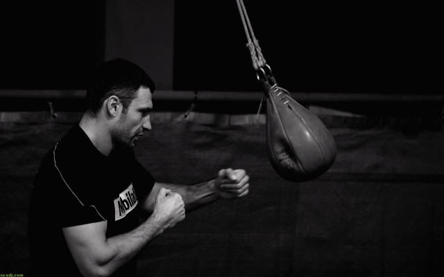 Man holding punching bag gym free wallpaper - medium preview image