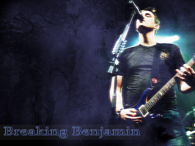 Man holding guitar singing into free wallpaper - medium preview image