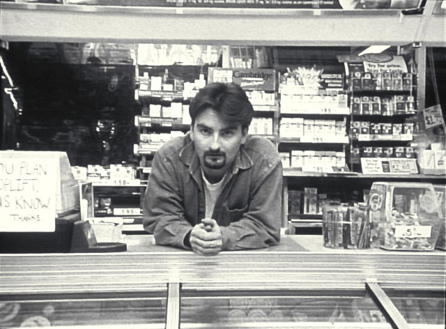 Man sitting counter store cell free wallpaper - medium preview image