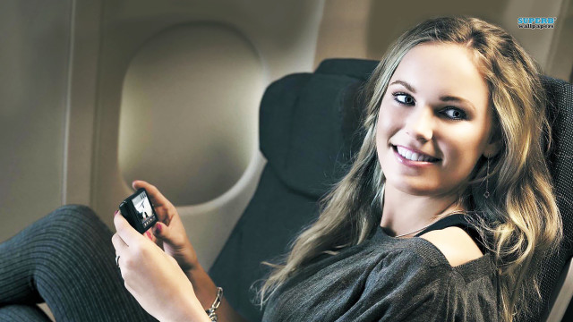 Woman chair cellphone smiling camera free wallpaper - medium preview image