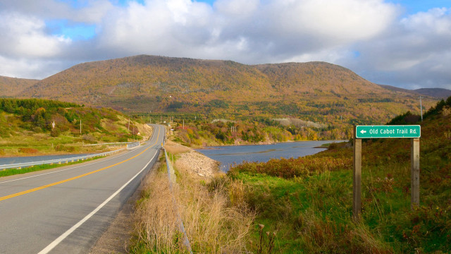 Road sign river mountains clouds free wallpaper - medium preview image
