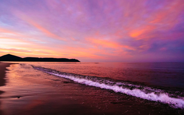 Beach wave sunset mountain distance free wallpaper - medium preview image