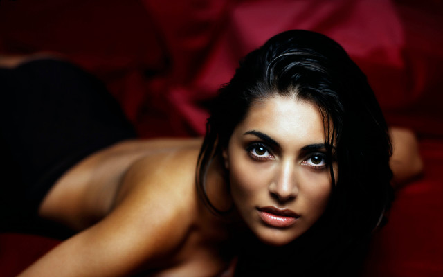 Woman laying red couch blurry free wallpaper - medium preview image