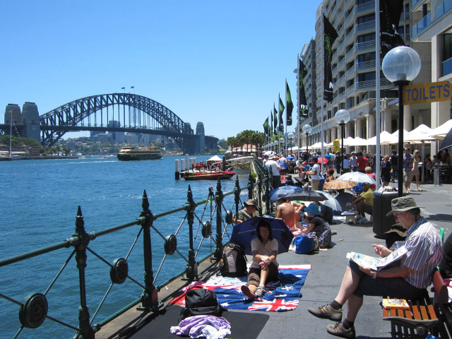 People sitting sidewalk water bridge free wallpaper - medium preview image