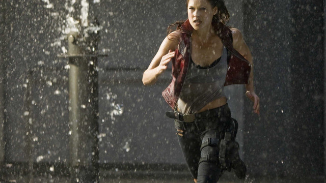 Woman running rain gun vest free wallpaper - medium preview image