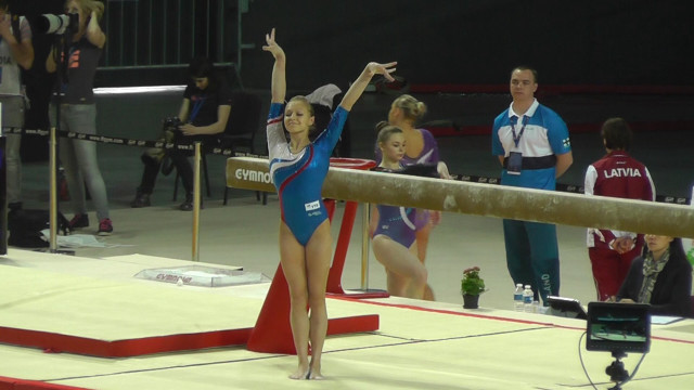 Woman blue leotard beam trick free wallpaper - medium preview image