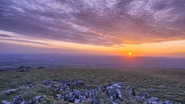 Sunset rocky field cloudy sky free wallpaper - medium preview image