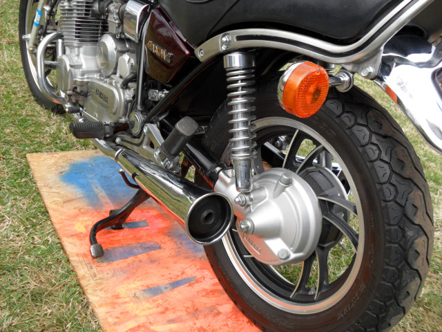 Motorcycle parked grass red light free wallpaper - medium preview image