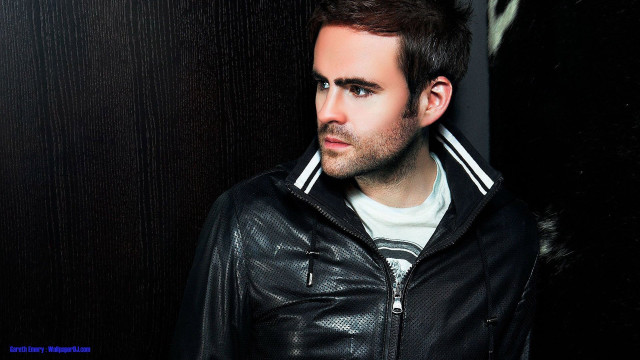 Man black jacket leaning wall free wallpaper - medium preview image