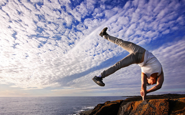Man handstand rock ocean sky free wallpaper - medium preview image
